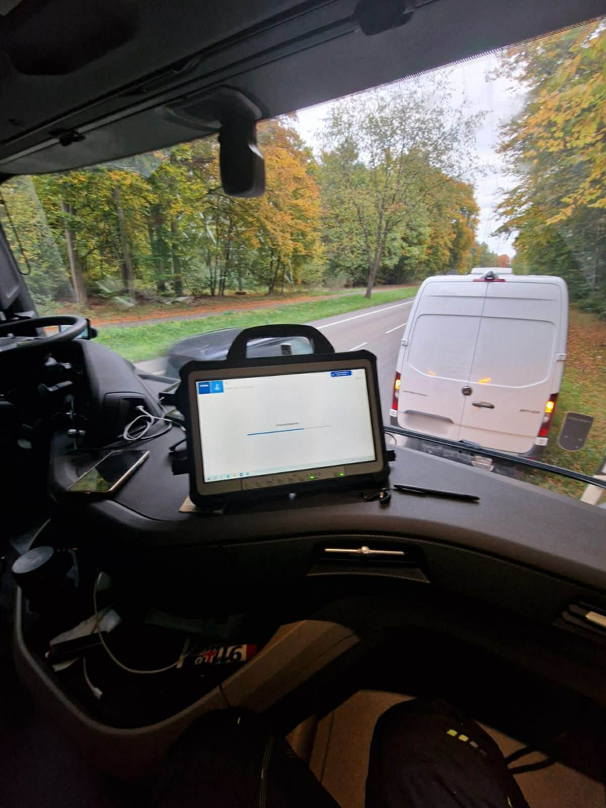 Diagnostic equipment in truck cab with service van visible